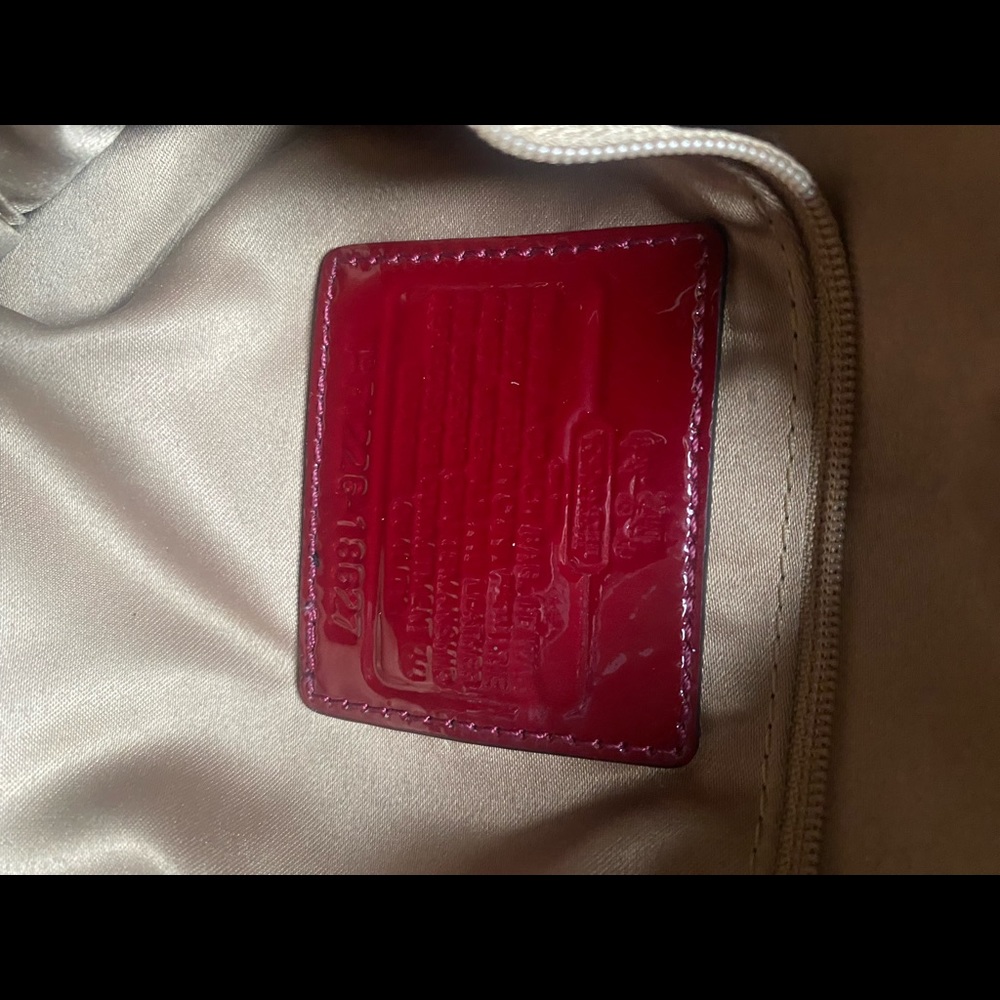 Burgundy patent leather Coach bag.